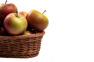 Wicker basket of fresh juicy apples isolated on white background