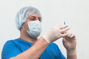 A Medical worker on a white background wearing gloves and a mask