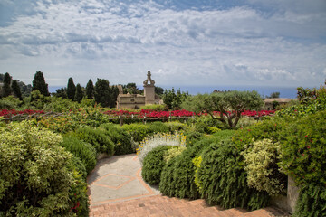 Beautiful view over the garden of Augustus on the mediterranean sea.View of the baroque clock tower of the Carthusian monastery in the Gardens of Augustus on Capri Island, Tyrrhenian sea, Italy