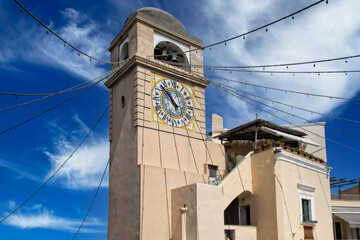 Clock tower of Church of Saint Santo Stefano in Capri town in Italy. Tower with old clock and bells...