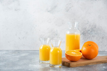 Glass pitchers of juice with slice of orange fruit