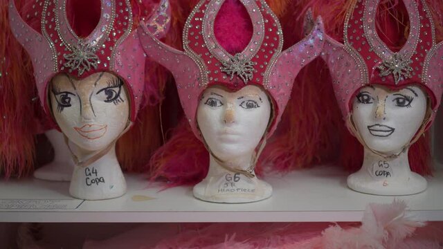 Mannequins of womens heads with red feather hats for burlesque dance, cancan, cabaret