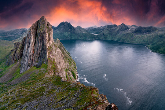 Segla Mountain from a nearby peak during sunset. The sky turned bright red orange and purple to give this image a dramatic variation to typical Norwegian landscapes. Heston Hike