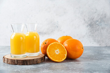 Glass pitchers of juice with slice of orange fruit