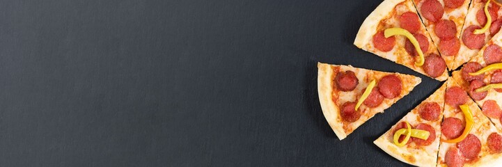 slice of pepperoni pizza on wood background . Top view of hot pepperoni pizza. With copy space. Flat lay. Banner.