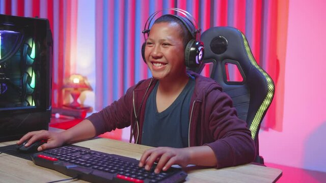 The Boy Feels Funny When Playing A Video Game,Child In A Headset Focused On A Computer Game
