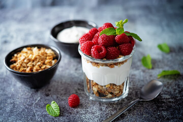Raspberry Greek yogurt granola parfait in a glass