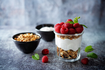 Raspberry Greek yogurt granola parfait in a glass