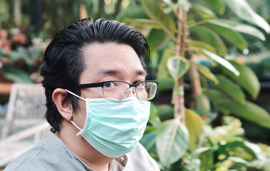 Asian men wearing mask for protect
PM2.5 dust, air pollution, and  coronavirus concept - 419934318