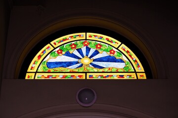 Hemisphere colorful stained glass window in a staircase of a on residential house with tee house...