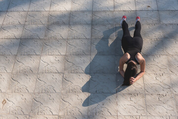 Photo of attractive woman in fashionable sportswear during workout. Sun spot. Sport and healthy lifestyle. Place for text.