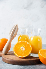 Glass pitchers of juice with slice of orange fruit