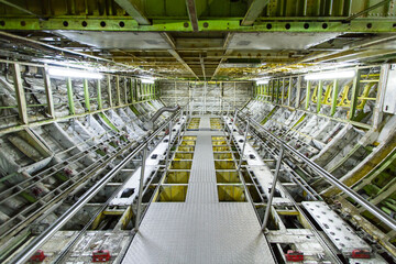 Inside view of airplane fuselage lower deck cargo hold - obrazy, fototapety, plakaty