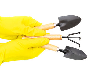 Set of garden hand tools in gloved hands isolated on white