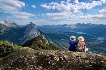 Adventurous couple on mountain top looking at scenic view. Kananaskis. King's Creek Ridge. Alberta....