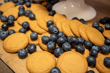 A large pile of ginger biscuits and blueberries