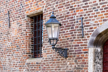 old lantern on an old brick wall on the street of the city of xantheth in germany