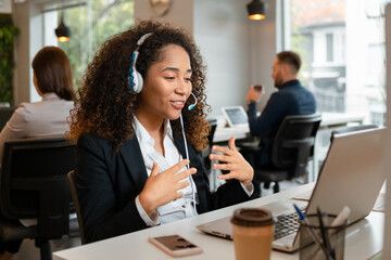 african american woman using laptop online meeting in video call at desk. .