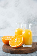 Glass pitchers of juice with slice of orange fruit