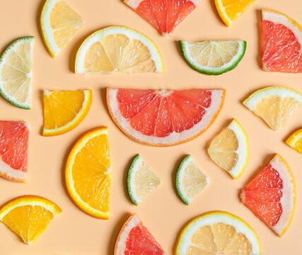 bright citrus fruits in even geometric layout on a pastel background