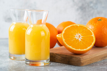 Fototapeta na wymiar Glass pitchers of juice with slice of orange fruit