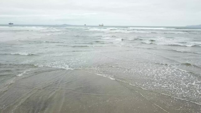 aerial shot of the coming tide at an estuary entrance