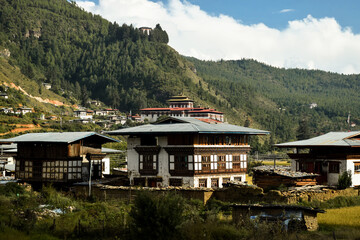 Traditional bhutanese buildings with mountains in the background. Paro, Bhutan.