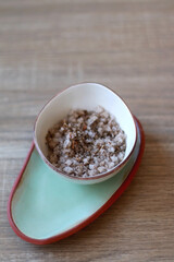 Bowl of sea salt mixed with Mediterranean herbs. Selective focus.