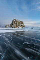 Windy day with clear sky on the lake. Snow motion over ice surface on lake Baikal, Siberia, Russia.