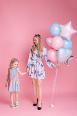 mom and daughter on family day with balloons