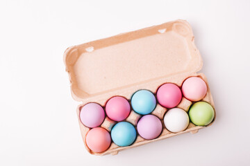 Colorful easter eggs in pack over white table