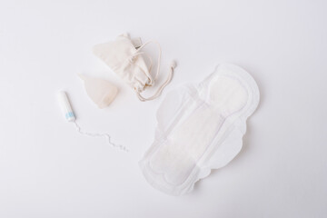 Fototapeta na wymiar Photo of tampon, menstrual cup.Concept of critical days, menstruation, over white background