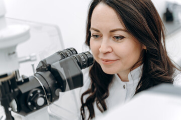 Ophthalmologist works with the help of special medical equipment and examines the vision in the...