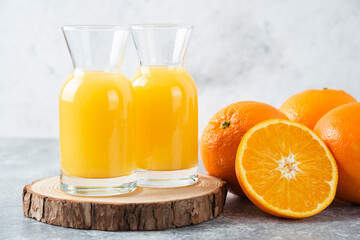 Glass pitchers of juice with slice of orange fruit
