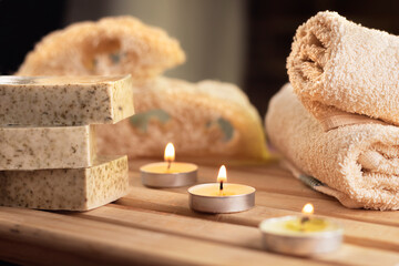 Obraz na płótnie Canvas spa, candles, natural organic soaps, plants, natural loofah, towels, fragrance in incense, in a warm place for skin treatments
