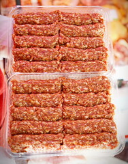 Romanian uncooked meat rolls called mititei, mici - close-up. Romanian traditional food