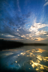USA, Michigan, Upper Peninsula. Sunrise sky reflected in Pete's Lake.