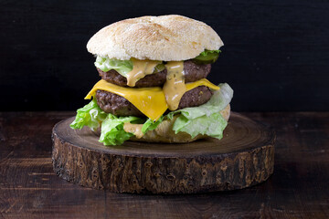 double cheeseburger on a wooden board