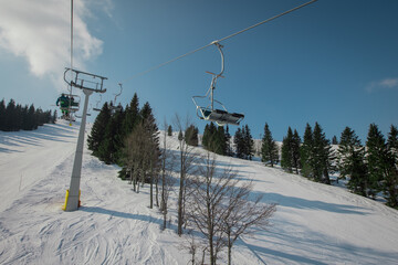 Old and worn gondola or ski lift on Soriska planina in slovenia on a sunny winter day.