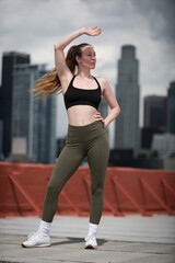 Fototapeta premium Young Athlete Warms Up on Los Angeles Rooftop