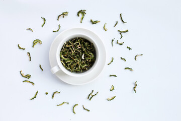 Dried bitter gourd in white cup on white