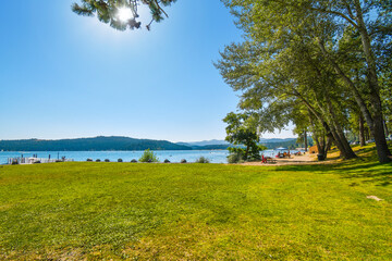 Tourists and local Idahoans enjoy a summer afternoon at the City Beach and Park along Lake Coeur d'Alene, in the Inland Northwest of the US.