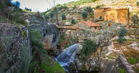 Ancient stone houses village with water channels to use as a water mill. Stone houses with river waterfalls