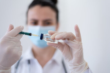 Nurse or female doctor prepairs anti COVID-19 vaccine dose for a patient