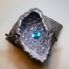 Bag of Diamonds and one semi-precious blue stone. 