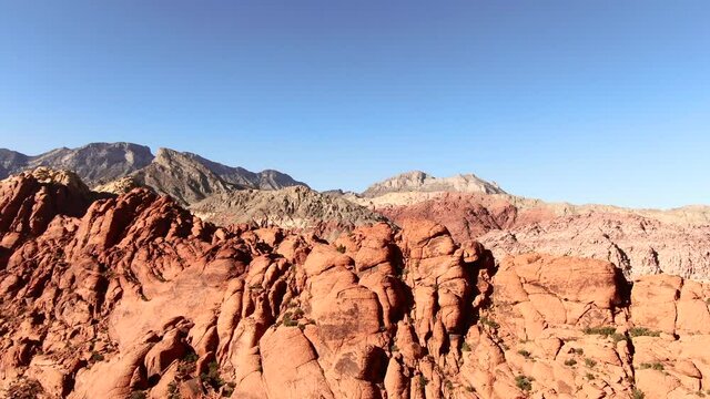 4K Aerial drone shot of a set of large red rock formations in the The Red Rock Canyon National Conservation Area in Clark County, Nevada