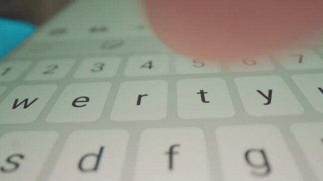 Timelapse of using a smartphone keyboard to type a message. Wide-macro shot.