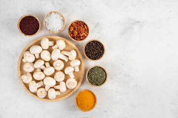 Mushrooms in a wooden platter served with variety of spices