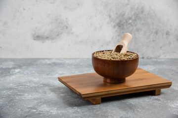 Bowl of raw split peas placed on wooden board