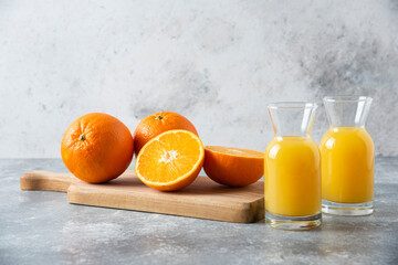 Glass pitchers of juice with slice of orange fruit